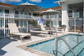 A pool with a no lifeguard on duty sign.
